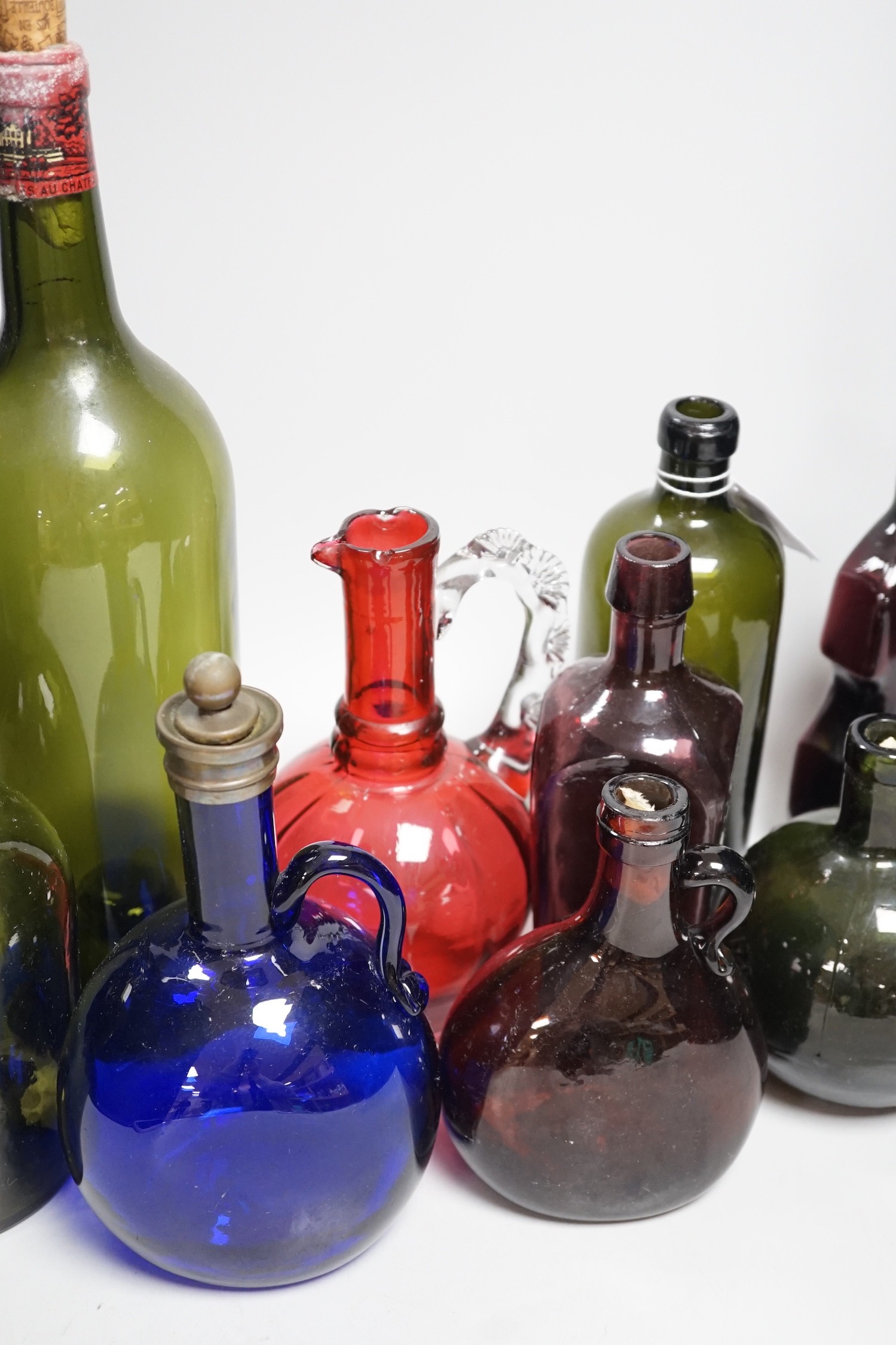 A collection 19th/20th century coloured glass bottles and jugs